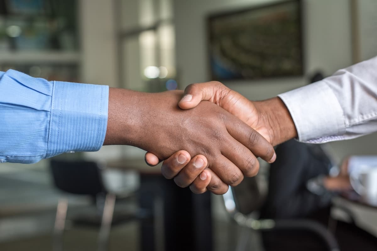 A Mossco Realty advisor and client shaking hands after a guided investment consultation